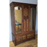 A mahogany and burr walnut fronted wardrobe, central decorative carved panel flanked by a pair of