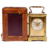 An Edwardian 8 day brass carriage clock, with original traveling case and key. 12cm tall.