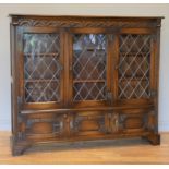 A Oak display cabinet by Bevan Funnell, three lockable (with keys) glazed lead fronted doors open to