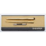 Sheaffer, a gold plated fountain pen with 14K gold nib, and a matching biro, cased