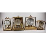 Kundo, a brass electronic mantel clock, lacking front glass, 24cm and three other similar clocks (4)