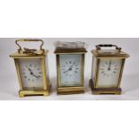 London Clock Co., a brass carriage time piece, 12cm, key, a St. James Metamec time piece and a