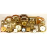 A collection of mechanical and quartz clocks, including mantel, alarm, lantern, anniversary clocks