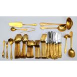 A German gold plated canteen of cutlery for 12 place settings, table knives, table spoons, table