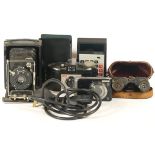 A Canon Powershot A3150 IS digital camera, together with a Plavic Anastigmat Gitzo folding camera, a