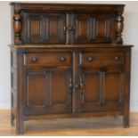 A 20th century oak buffet, with two lockable hinged doors over two drawers over two