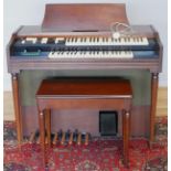 A Wurlitzer electric organ, model 4040R (serial No 985822), with stool