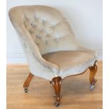 A Victorian nursing style arm chair, walnut framed, low arm rest, button backed, upholstered in grey