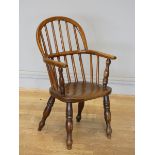 A child's early 20th century Windsor armchair, turned supports on similarly turned legs, oak