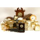 A collection of mechanical and quartz clocks, including wall, anniversary, carriage, mantel, desk