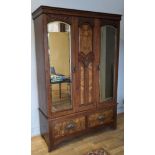 A mahogany and burr walnut fronted wardrobe, central decorative carved panel flanked by a pair