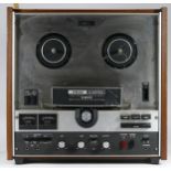 A Teac A-4070G reel to reel stereo tape deck, with original manual