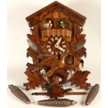 A Black Forest Cuckoo clock, made in Germany, with head piece in the form of a bird, weights,