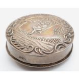 A silver pill box, Birmingham 1930, with embossed cherub, 36mm, 16gm