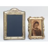 An arched silver photograph frame, Sheffield 1992, 24 x 17cm, and an EPNS photograph frame,