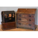 An early 20th century oak bureau, a single lockable hinged door opens to reveal a fitted shelved