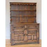 A early 20th century oak dresser, with shelved shelved plate rack over two small drawers over