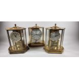 Kundo, a brass electronic mantel clock, 24cm and two anniversary clocks, one lacking pendulum (3).