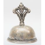 A Swedish silver table bell, by C.C., 1863, with mask handle and floral engraved body, ball clanger,