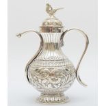An Indian silver long spout pot, stamped 925, with embossed and chased decoration, 13.5cm 199gm