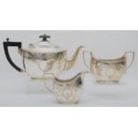 A silver three piece tea service, by Barker Bros., Chester 1918/34, of oval form with engraved