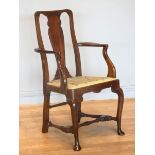 A Georgian mahogany armchair, with shepherd crook arms and vasiform splat beneath a yoke crest rail,