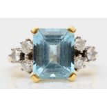 An 18ct gold aquamarine and diamond dress ring, claw set with a step cut stone, 11 x 9mm,