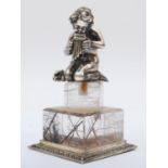 A German 800 standard silver child playing a flute raised on a quartz pedestal with silver base, 9.
