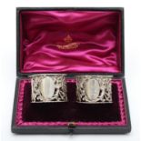 A Victorian silver pair of napkin rings, Sheffield 1895, with pierced and embossed floral