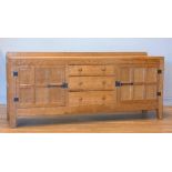 A Peter 'Rabbitman' Heap of Wetwang oak panelled sideboard, with raised upstand above two cupboard