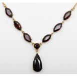 A 9ct gold and garnet necklace, with pear shape drop, 16 x 8mm, to six navette stones, 39cm, 6.5gm