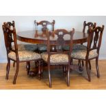 A Victorian mahogany pedestal dining table with circular tilt top supported by a turned column on