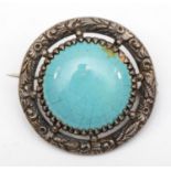 A silver Arts and Crafts brooch, mounted with a Ruskin turquoise pottery disc, signed, 30mm