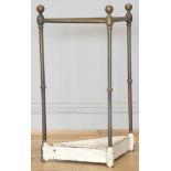 An Edwardian brass corner umbrella stand, with four divisions on a cast iron base with inset drip
