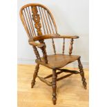 A 19th century elm and yew wood hoop back Windsor chair, the stick back centred with a pierced splat