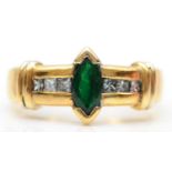 An 18K gold emerald and blue diamond (untested for colour) dress ring, set with a navette stone