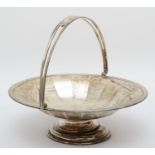 A silver swing handle pedestal basket, Birmingham 1922, of paneled form, with reeded border, 25x