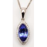 A 14K white gold, tanzanite and brilliant cut diamond navette pendant, stone 11 x 6mm, of good