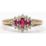 A 9ct gold three stone ruby and diamond cluster ring, the graduated stones bordered by brilliants, Q