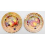 Two Royal Worcester side plates, painted in polychrome enamels with still lifes of fruits on a mossy