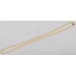A uniform 7mm bead cultured pearl necklace, 61cm, to a 9ct gold and pearl cluster clasp