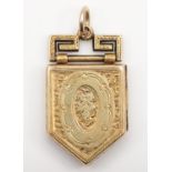 A Victorian gold cased shield shape locket, metal frame, with engraved decoration, 27 x 17mm