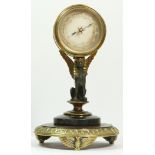 A late 19th century brass aneroid barometer, raised on a bronzed patinated sphinx, to a brass