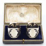 A silver pair of napkin rings, Birmingham 1922, with pierced decoration, 41gm, cased
