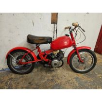 A child's single cylinder motorcycle, twist and go.