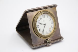 A silver cased travelling 8 day bedside clock, London 1920, with engine turned decoration, 9.5 x 9.