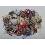 A quantity of costume jewellery and watches.