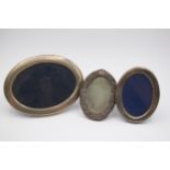 An oval silver photograph frame, Sheffield 1984, 17 x 13cm and two other silver frames