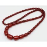 A cherry red amber Bakelite graduated bead necklace, 25 - 12mm beads, 92cm, 96gm