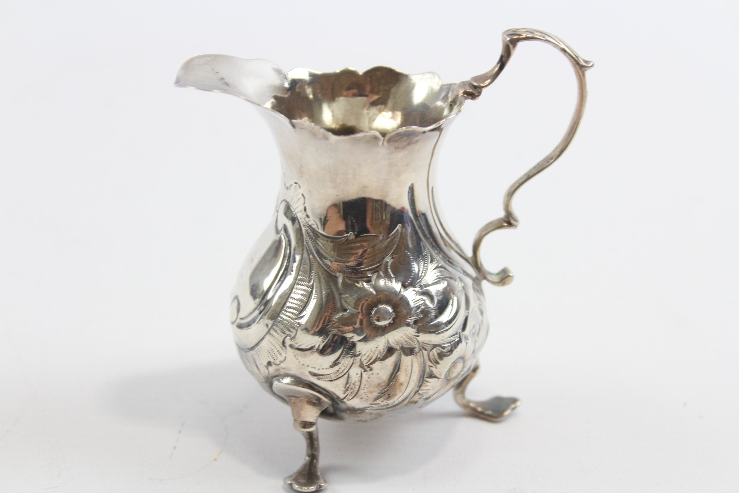 A George III silver embossed cream jug, London 1763, 9.5cm, 69gm - Image 2 of 6